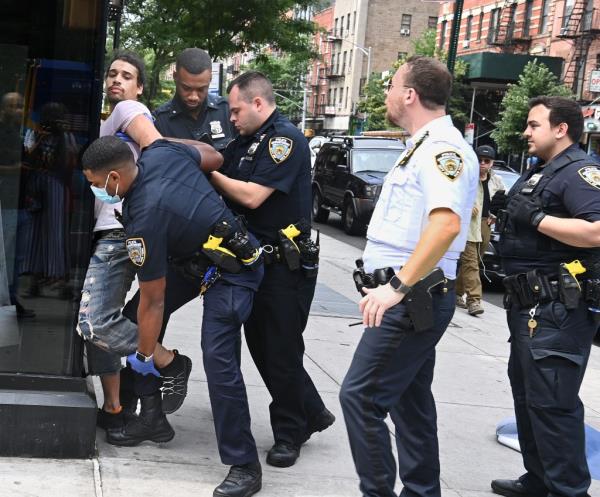 NYPD officers subdue a suspected shoplifter outside a Target in June. Retail theft has taken a toll on chains including Target.