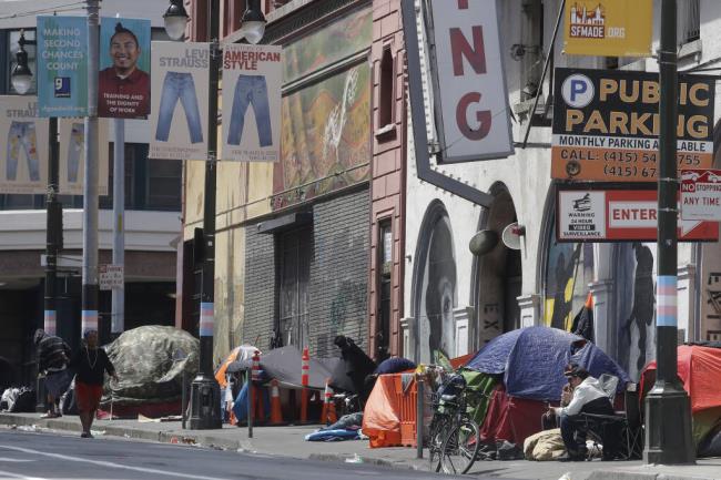 FILE - Tents line a sidewalk in the Tenderloin neighborhood of San Francisco on April 18, 2020.  (AP Photo/Jeff Chiu, File)